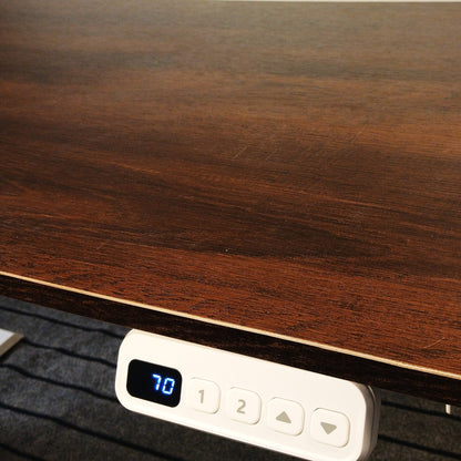 Electric standing desk with dark brown textured tabletop